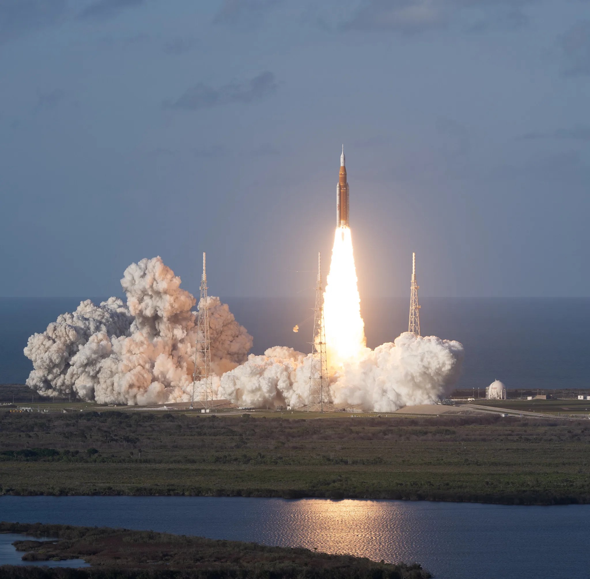 The Artemis II rocket blasts off from Kennedy Space Center leaving behind a plume of smoke.