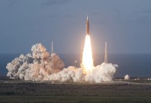 The Artemis II rocket blasts off from Kennedy Space Center leaving behind a plume of smoke.
